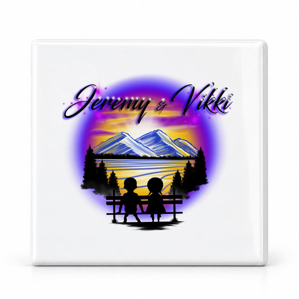 E028 Boy Girl Mountains sunset Trees Scene ceramic coaster by Mythic Airbrush, original Air-Volution design — main image